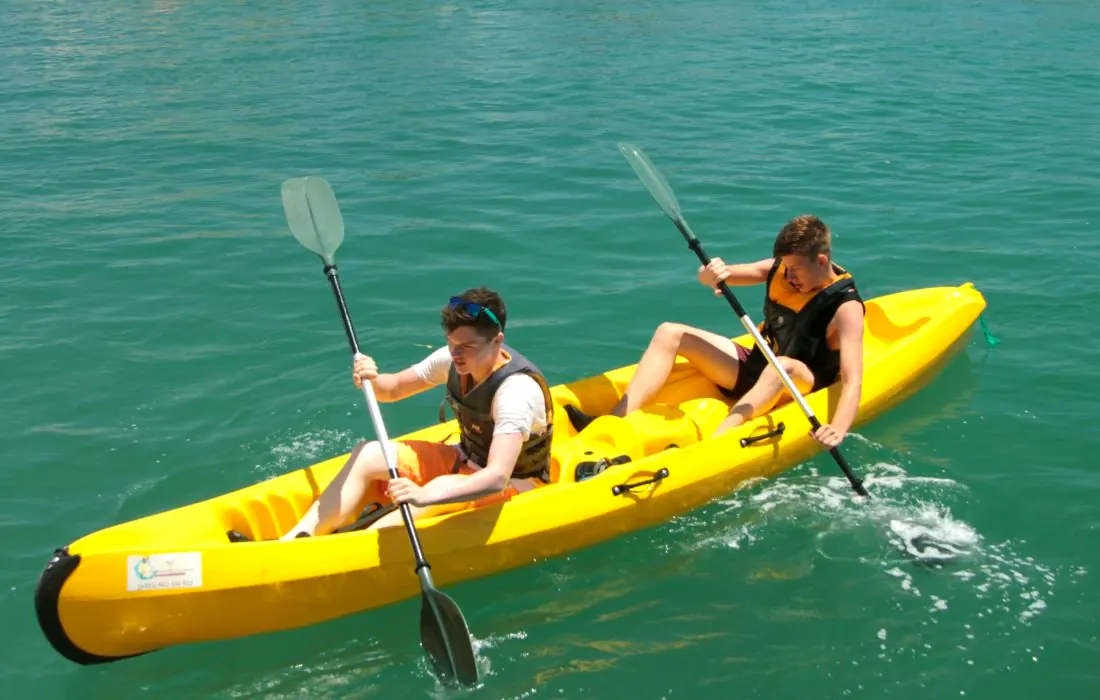 Two paddlers in a yellow double kayak